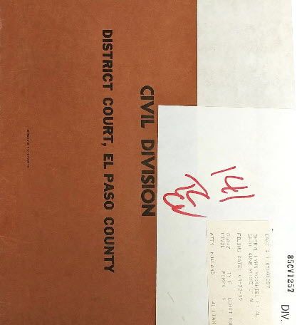 A brown case file folder labeled 'Civil Division, District Court, El Paso County,' with a handwritten docket number '141' on a sticky note and a typed case information card attached to the front.