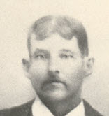 Black-and-white studio portrait of a young William Webster Bates, close-cropped, wearing a dark suit jacket, waistcoat, and high white collar with a light necktie. He has a full mustache and short, side-parted hair.